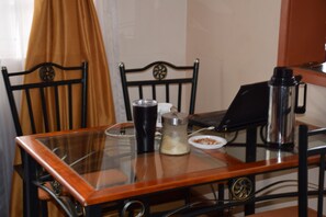 Enjoy meals and work sessions in this cozy dining area with a glass table and comfortable seating for two.