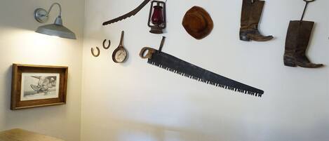 A wall with various tools and a framed picture.