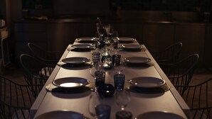 A long dining table set with plates, glasses, and a centerpiece. - Unique: magnificent villa in Porquerolles (Ile de Porquerolles)