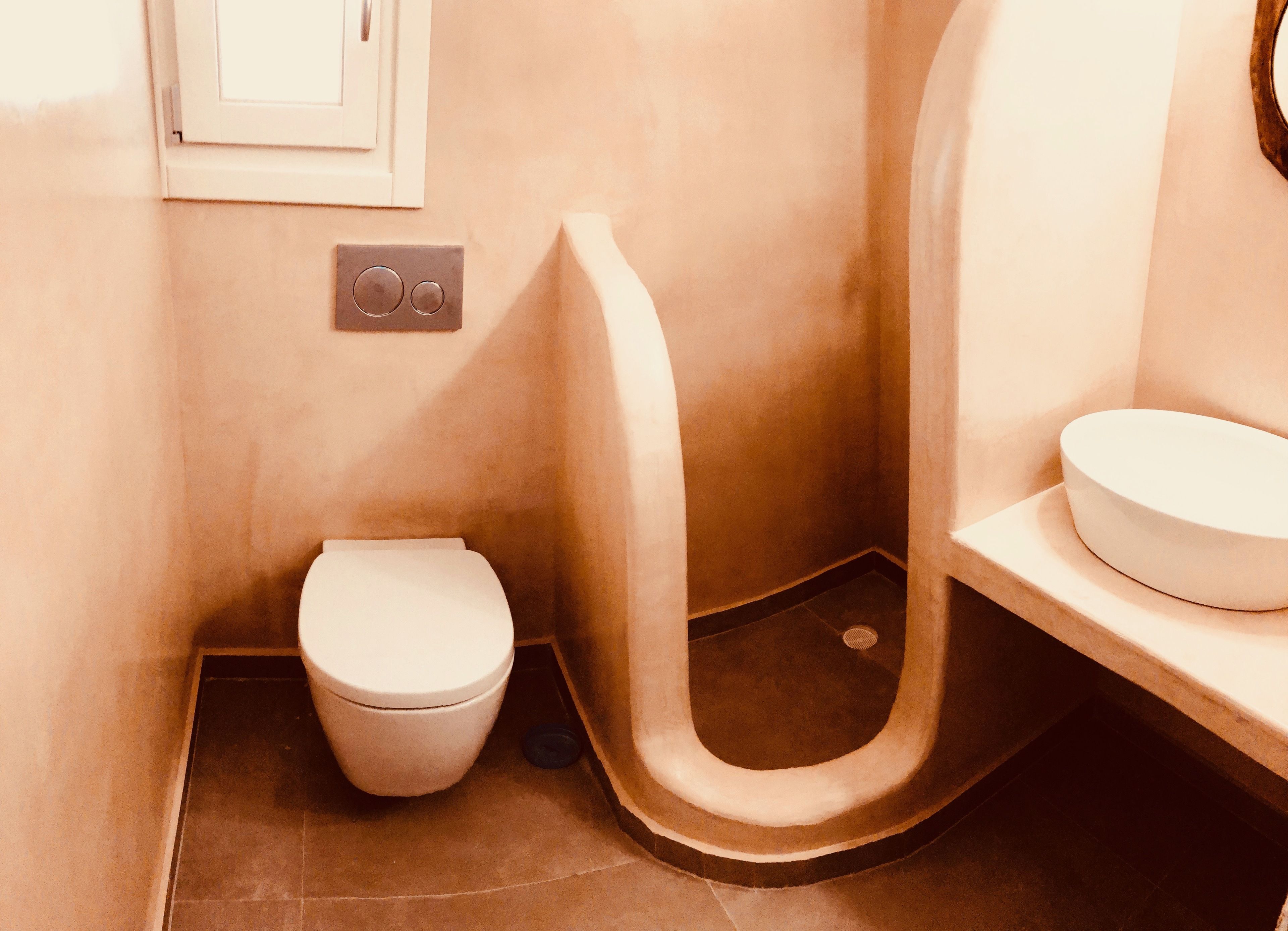 A compact bathroom with a toilet, urinal, and sink.