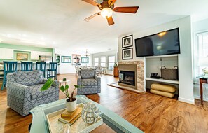 Cozy living area with a fireplace, flat-screen TV, and comfortable seating.