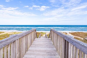 A wooden boardwalk leading to the beach with a clear view of the ocean. - A Big Catch - KDH MP 8.5, Oceanfront, Elevator, Pool, Hot Tub, Spacious, Pets OK, Flex Stays (Kill Devil Hills)