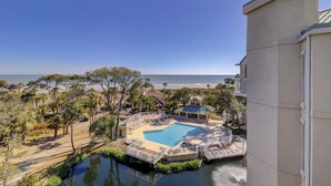 A resort with a pool, a beach view, and a water feature. - 503 Barrington Arms - Crisp and Beachy.  What a View! (Hilton Head Island)