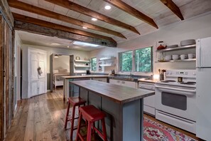 Enjoy cooking in this well-equipped kitchen with a central island and bar stools.
