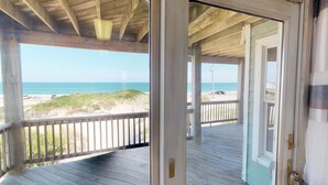 A wooden deck with a view of the beach and ocean. - Finding Sandity | 5BR 4x4 OBX | Pool, Hot Tub & Game Rm | Sleeps 10 (Carova)