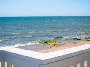 A beach with clear blue water and rocks. - Ocean Dunes 2002 | Oceanfront + Community Pool! (Kure Beach)
