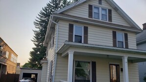 A two-story house with a front porch, a garage, and a driveway. - WOW! OleanGrt PriceEntire house! 4 bedrooms 2.5 baths 30 mins to Ellicotville (Olean)