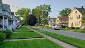 A residential street with houses, a white van, and a tree. - WOW! OleanGrt PriceEntire house! 4 bedrooms 2.5 baths 30 mins to Ellicotville (Olean)
