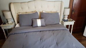 A bed with a tufted headboard, grey bedding, and two bedside tables with lamps. - WOW! OleanGrt PriceEntire house! 4 bedrooms 2.5 baths 30 mins to Ellicotville (Olean)