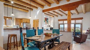 A rustic dining area with wooden furniture, a large table, and a view of the outdoors.