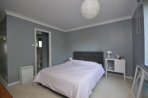 Cozy retreat with a large bed and a minimalist design.