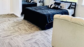 A bedroom with two beds, a ceiling fan, and large windows. - Views on a Hill..... (San Jose)