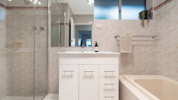 Bathtub, hair dryer, towels, soap