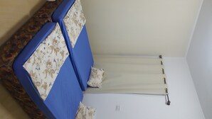 A room with a bed, a small table, and a wall-mounted radiator. - A charming F1 studio (Sahloul)