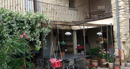 The eighteenth century house is opposite the fortified church of the village.