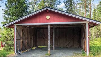 A red barn with a gabled roof and a single light fixture.