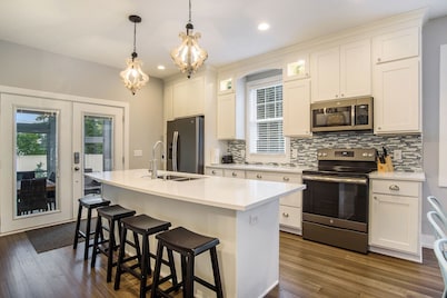 New Home with swim spa, theatre & game room. 1 block to town & close to beach.  