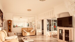 A living room with a sofa, coffee table, and a television. -  Relaxing villa. Heated pool. Luxurious views. Massage. (Santa Úrsula)
