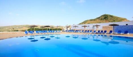 Seasonal outdoor pool, pool umbrellas, pool loungers