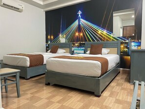 A hotel room with two beds, a nightstand, a chair, and a wall mural of a cityscape at night. - Cozi Hotel (Hai Phong)