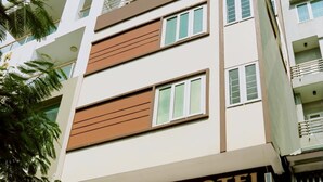 A hotel with a sign reading "COZI HOTEL" and a staircase leading to the entrance. - Cozi Hotel (Hai Phong)