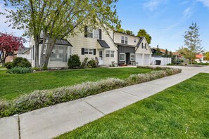 A two-story house with a front yard, a driveway, and a mailbox.