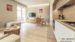 A modern apartment with a dining area, kitchen, and living space. - Baltic Apartments - Apartamenty Bałtyk (Swinoujscie)