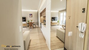 A modern apartment with a kitchen, dining area, and living room. - Baltic Apartments - Apartamenty Bałtyk (Swinoujscie)