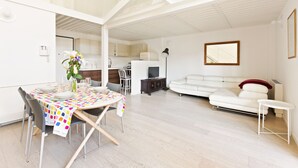 A modern living space with a dining area, kitchen, and seating area. - Elegant Loft with balcony (Milan)