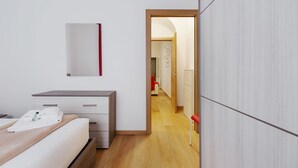 Una habitación de hotel moderna con una cama, un escritorio y un armario.