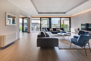 Luxury Apartment, 3 Bedrooms, Hot Tub, Partial Sea View | Living area | Flat-screen TV, fireplace, heated floors