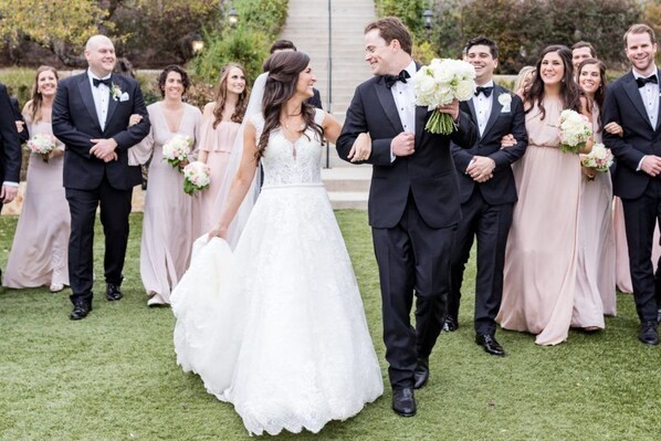 A wedding ceremony with guests in formal attire.