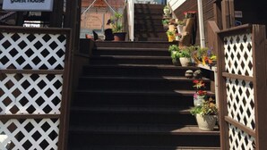 A guest house named HAGO with a staircase leading to a wooden deck area. - Hago Guest House (Tongyeong)