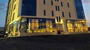 A modern hotel building with a prominent sign at the top reading "Muscat Hotel." - Muscat Gate Hotel (Muscat)