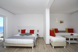 A modern bedroom with two beds, a sofa, and a small table. - Blu Acqua (Agios Nikolaos)