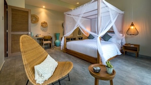 A room with a four-poster bed, a wicker chair, a small wooden table, and a wall-mounted lamp. - Lin Ubud (Ubud)