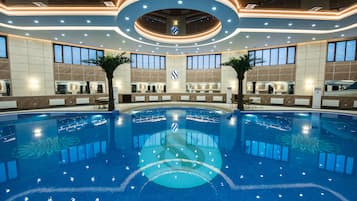 Indoor pool, open 9:00 AM to 12:30 AM, pool loungers