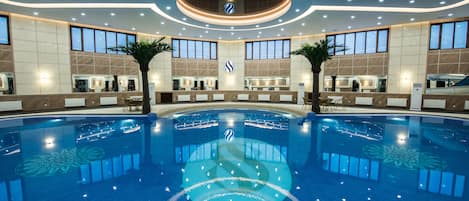 Indoor pool, open 9:00 AM to 12:30 AM, pool loungers