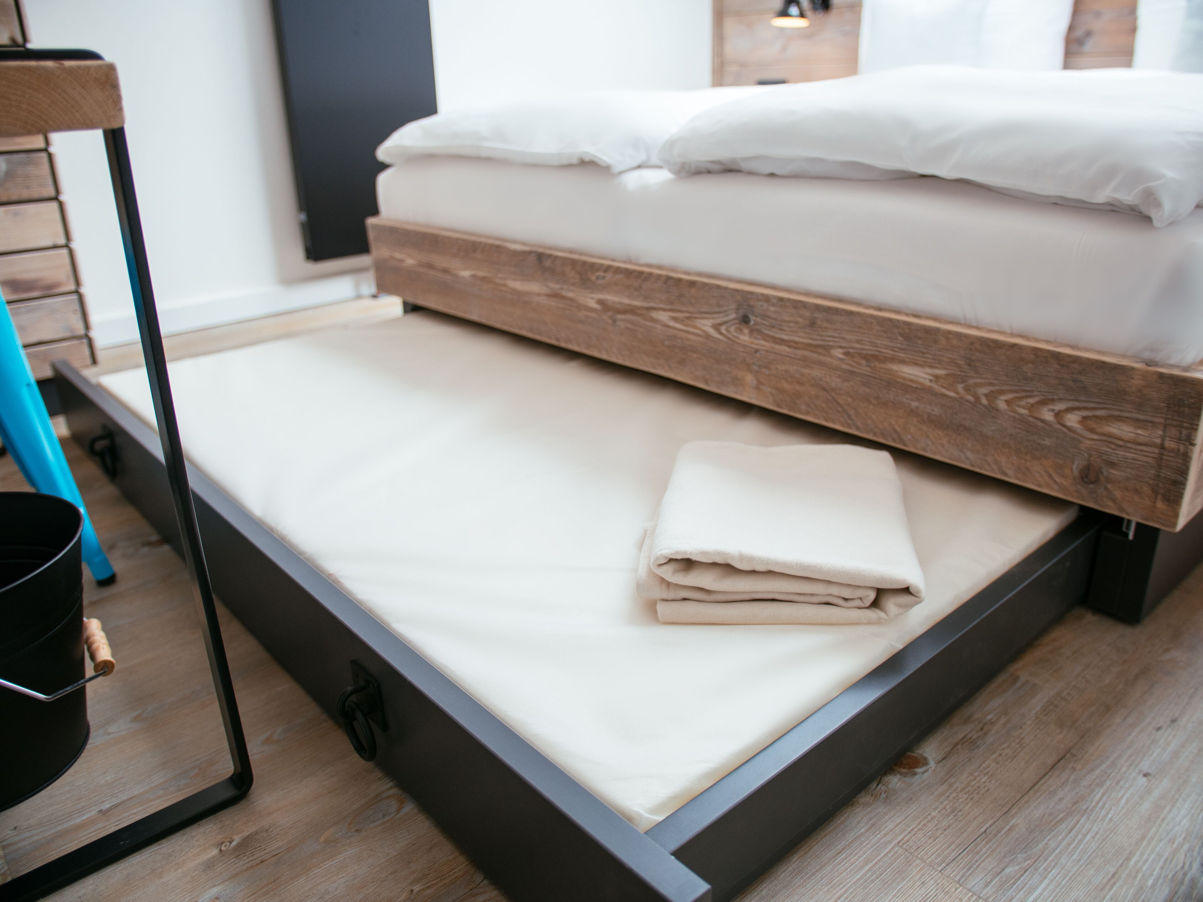 A bed with a wooden frame and a mattress.