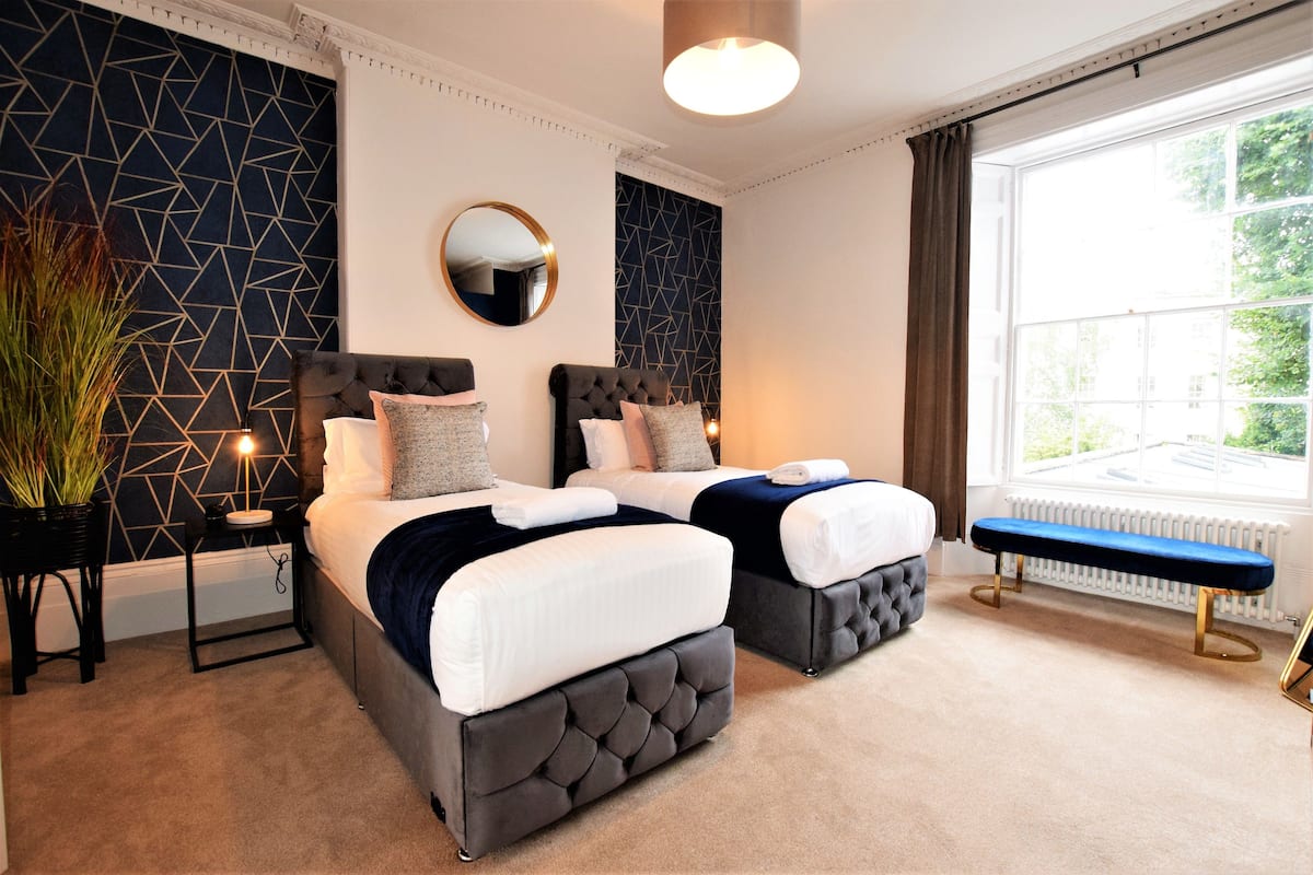 Premium bedding, desk, laptop workspace, iron/ironing board