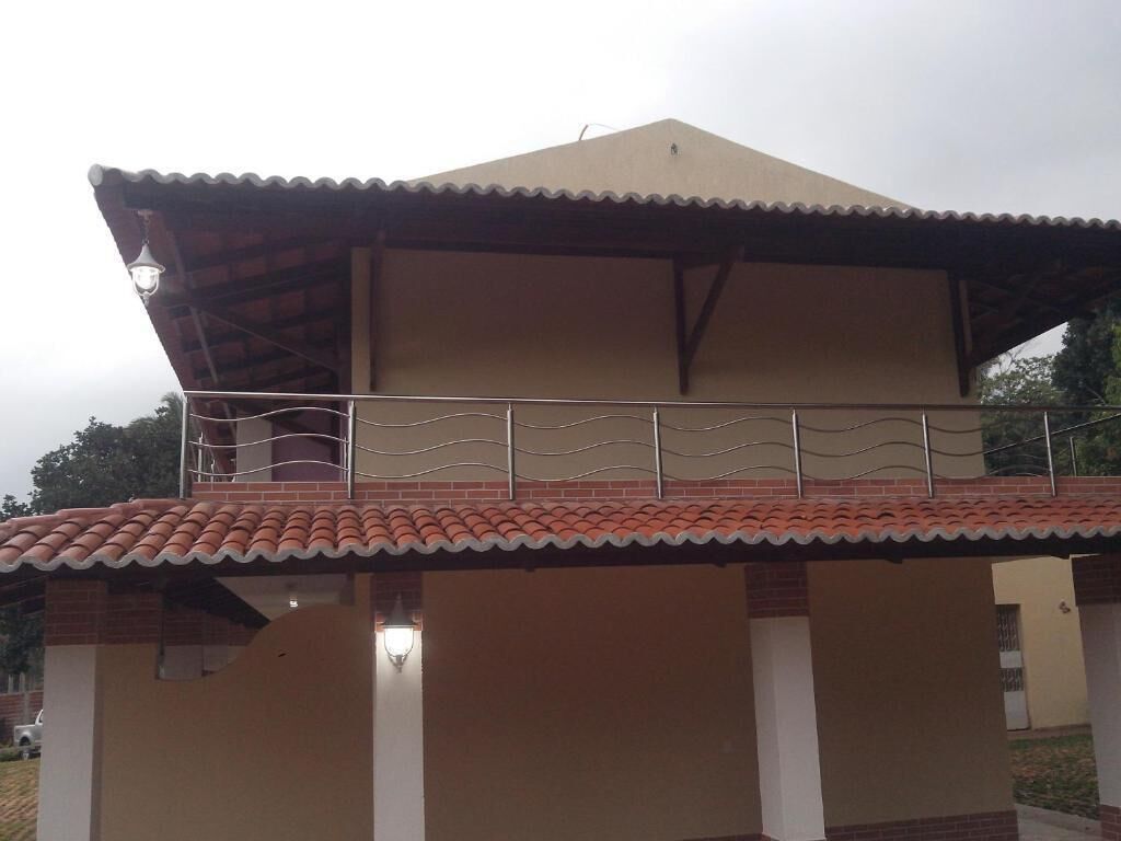 Un edificio a due piani con tetto piatto e un balcone.