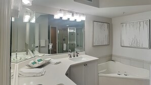 A modern bathroom with a large sink, a bathtub, and a mirror. - Lovers Key Resort 404 by Distinctive Beach Rentals (Fort Myers Beach)