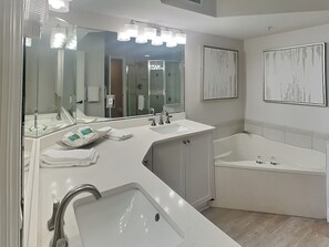 A modern bathroom with a large sink, a bathtub, and a mirror. - Lovers Key Resort 404 by Distinctive Beach Rentals (Fort Myers Beach)