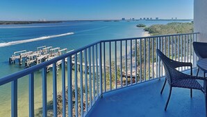 A balcony with a view of a marina and a clear blue sky. - Lovers Key Resort 403 by Distinctive Beach Rentals (Fort Myers Beach)