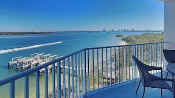 A balcony with a view of a marina and a clear blue sky.