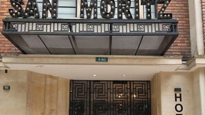 A hotel entrance with a large sign reading 'SAN MORITZ HOTEL' above a decorative metal entrance. - Hotel Museo San Moritz (Bogotá)