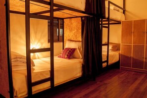 A bunk bed room with a wooden floor, a wardrobe, and a window. - Xplora Hostel Cusco (Cusco)