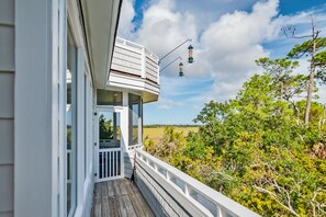 Property grounds - Large windows taking in the marsh views on BHI; reverse floor plan and large deck for views! (Bald Head Island)