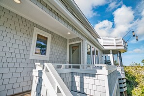 Exterior detail - Large windows taking in the marsh views on BHI; reverse floor plan and large deck for views! (Bald Head Island)