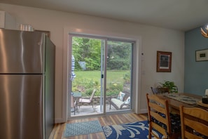 Enjoy meals in the kitchen with a dining table and chairs, and step outside to a patio with a table and chairs.